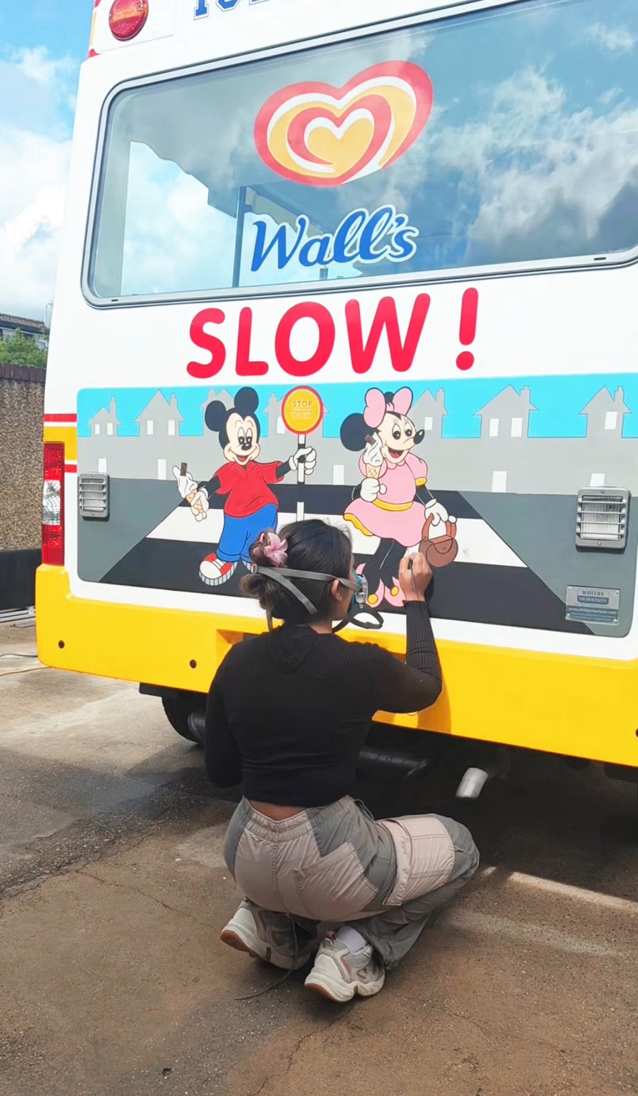 Shehara painting a child-safety mural on a Walls ice-cream van